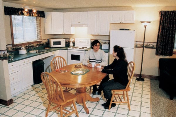 Couple having coffee at kitchen table.