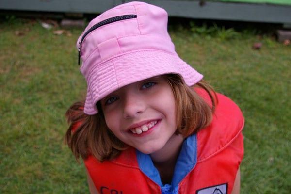 Young girl with a pink suncap.