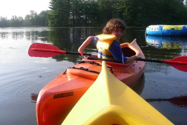 Young person in a kayak.