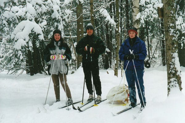Group of skiers in forest.