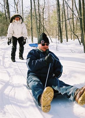 Adult man on sled.