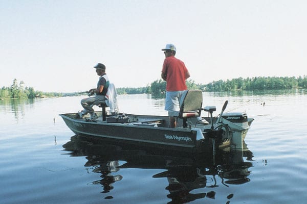 Two men fishing on a boat.