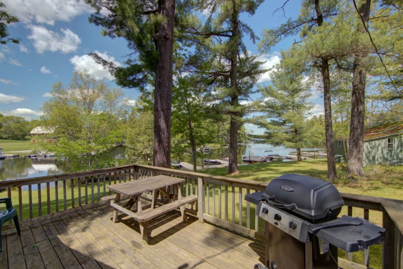 Pinerest patio deck with gas grill and picnic table.