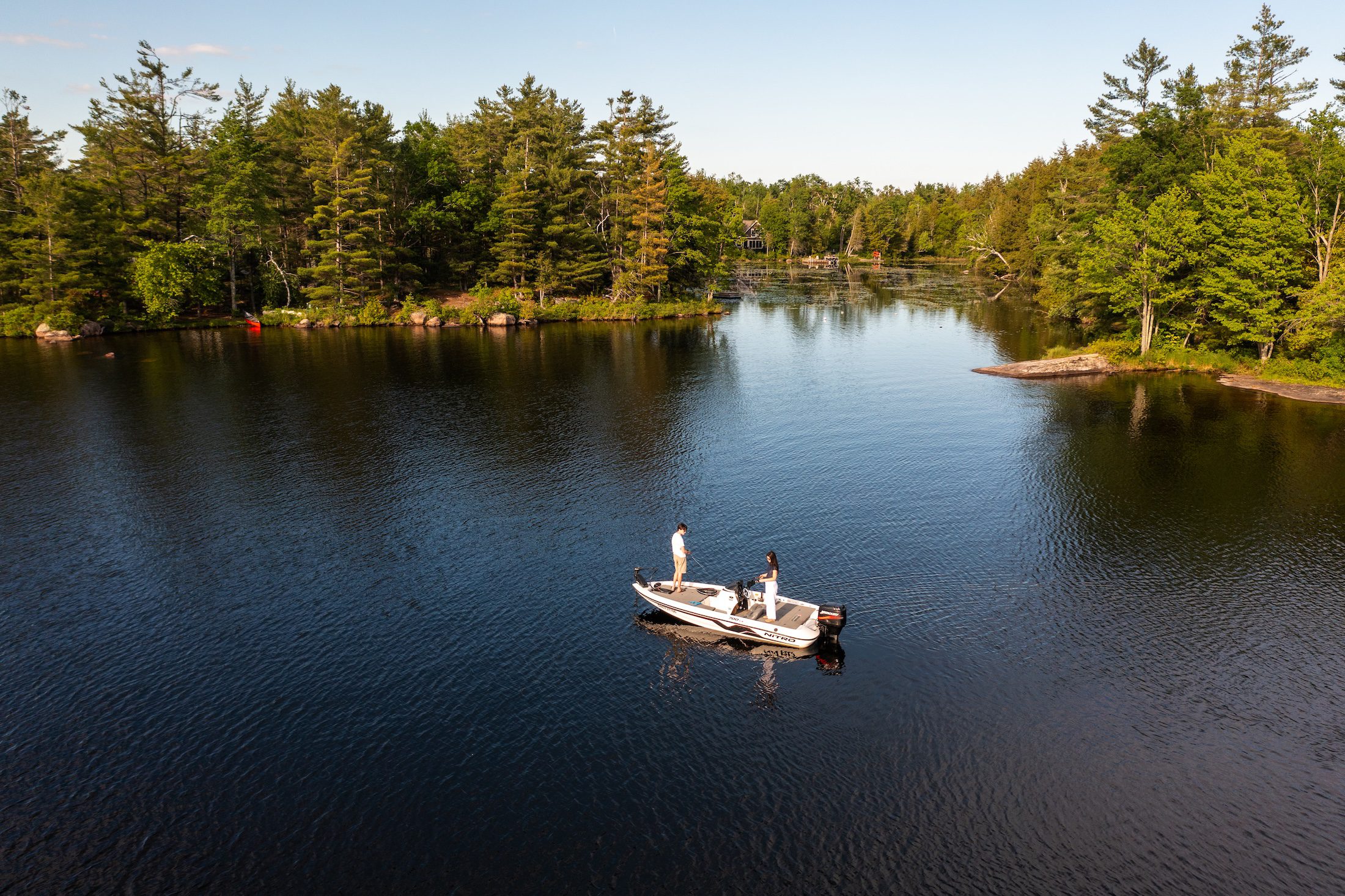 Aerial view of two people in a boat in sheltered bay